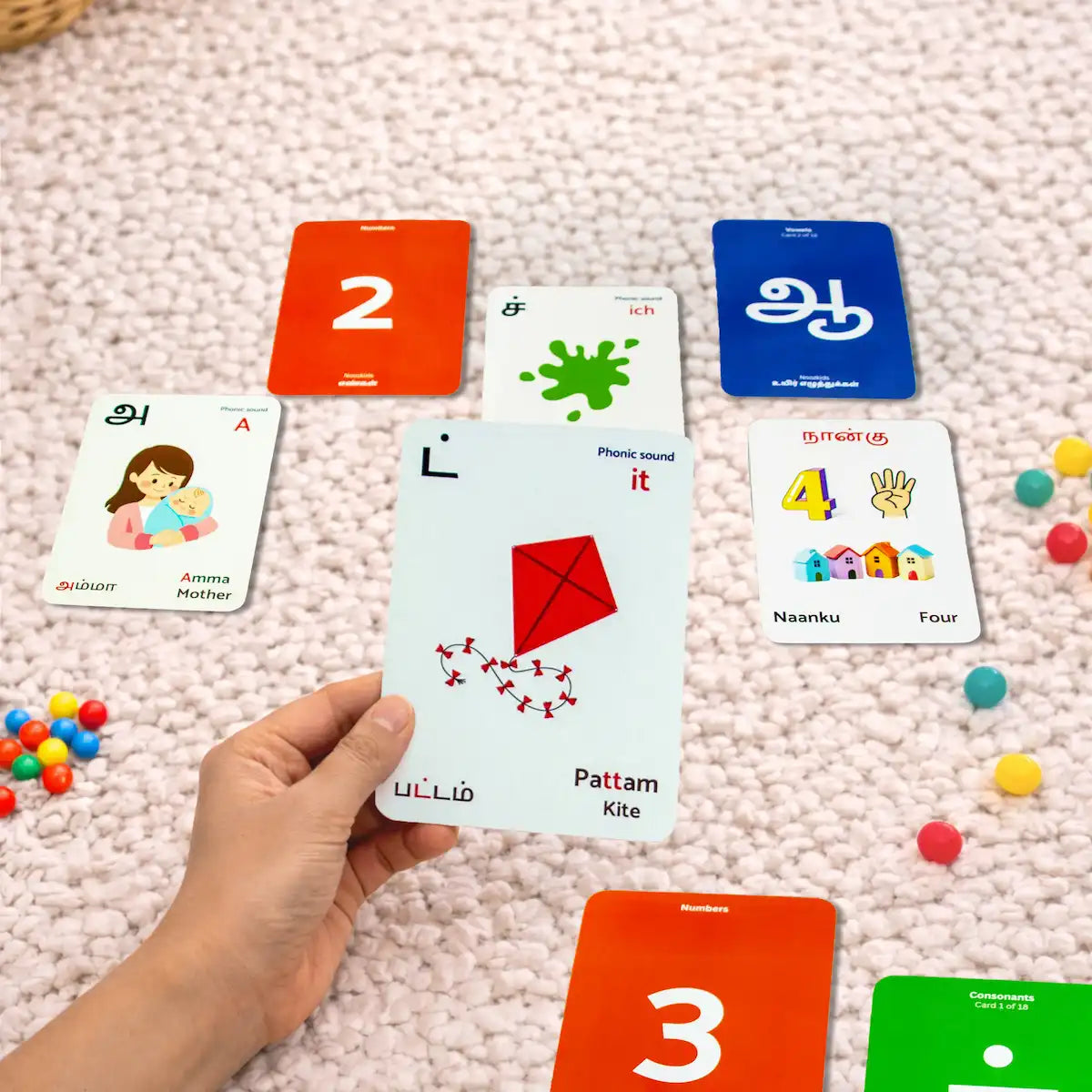 Educational cards with numbers and letters on a pink carpet